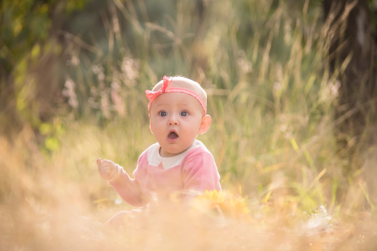 Photo of a Baby Girl Wearing Pink Headband